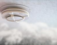 Smoke alarm on ceiling with smoke