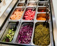 Buffet station filled with cut up food options