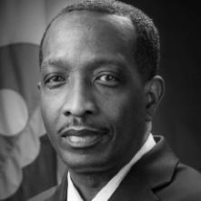 Headshot of a Black man in a suit