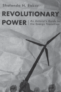 A wind turbine held by a dark skinned hand and other hands held up in fists