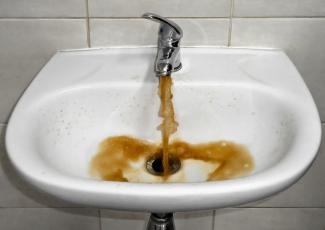 bathroom sink dispensing brown colored water