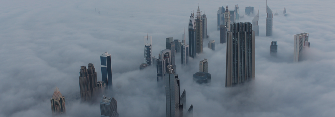 Image of Dubai with buildings popping out of clouds/fog